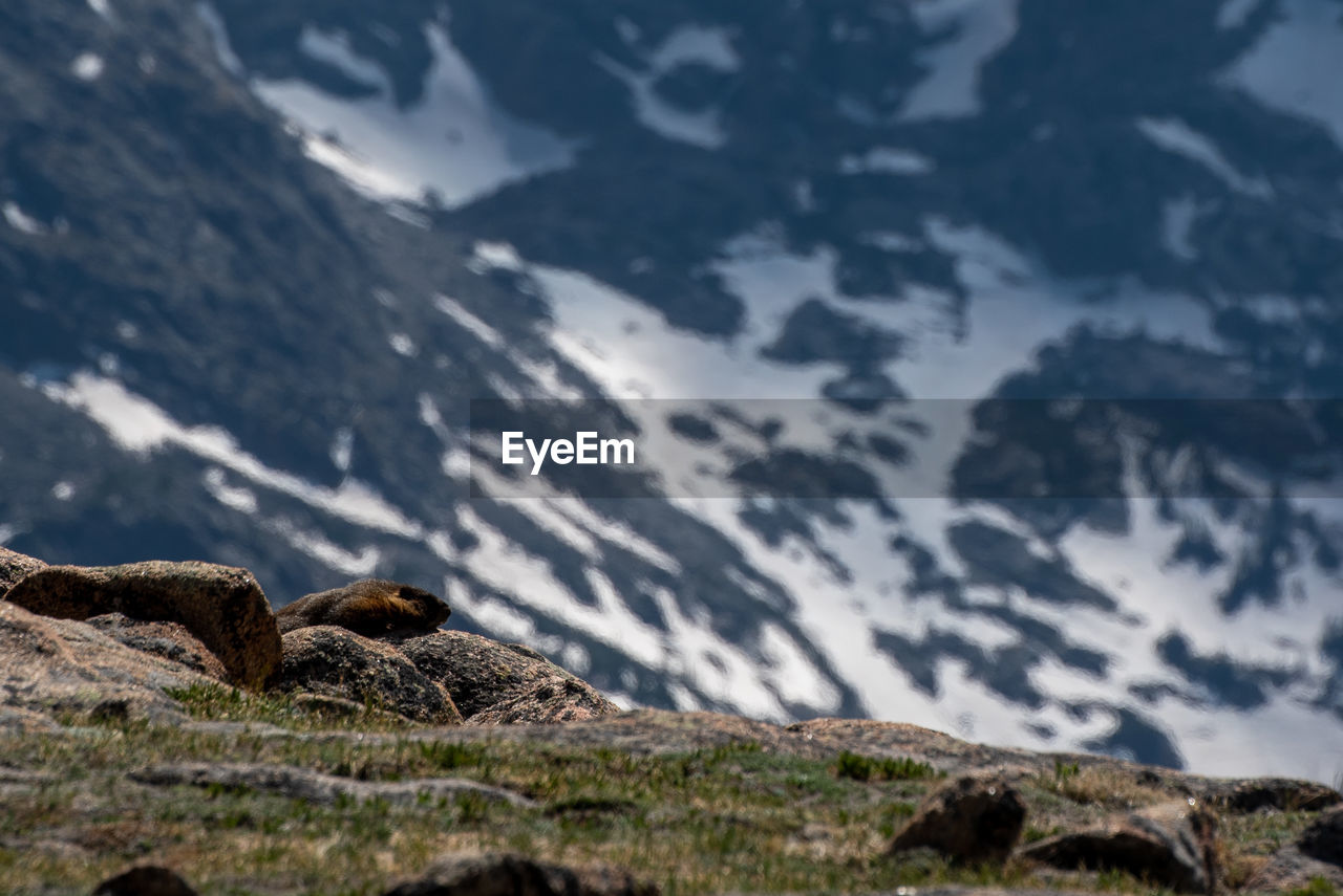 ROCKS ON MOUNTAIN AGAINST SKY