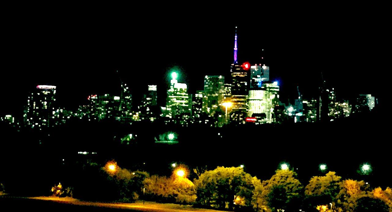 VIEW OF ILLUMINATED CITYSCAPE AT NIGHT