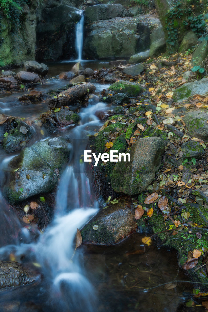 STREAM FLOWING THROUGH ROCKS