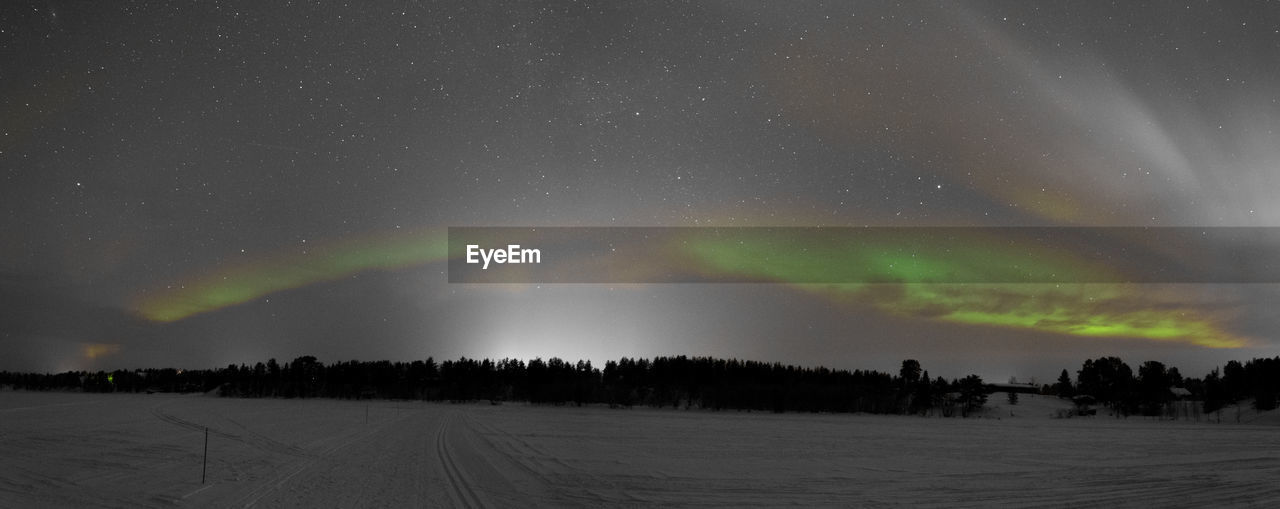 Scenic view of landscape against sky at night during winter