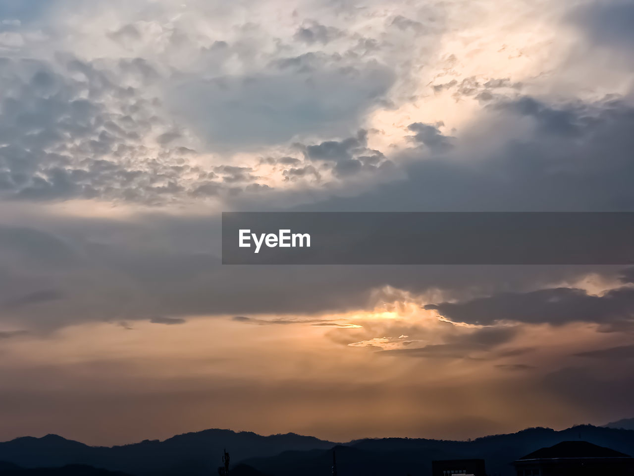 LOW ANGLE VIEW OF SILHOUETTE MOUNTAIN AGAINST DRAMATIC SKY