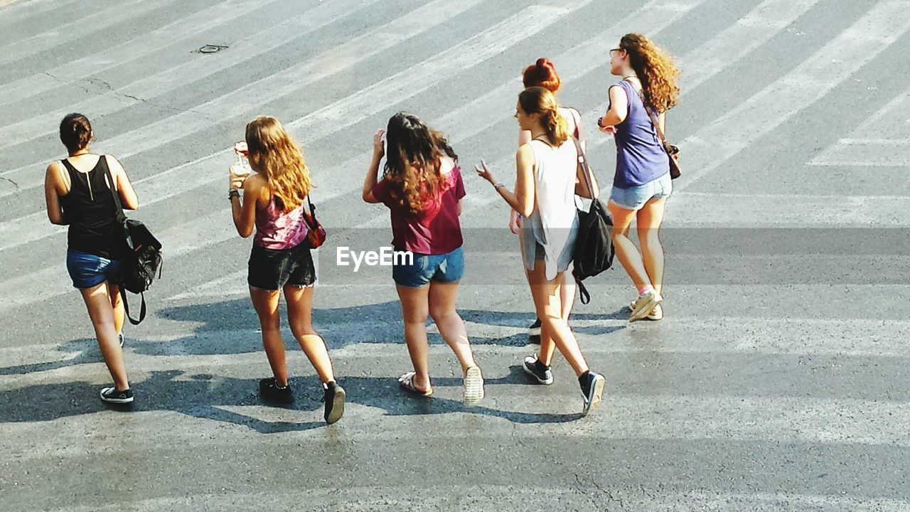 GROUP OF PEOPLE STANDING ON TILED FLOOR