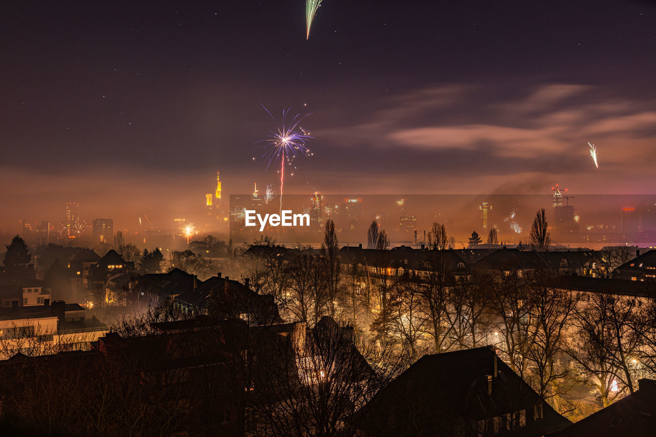 FIREWORK DISPLAY OVER CITY AGAINST SKY