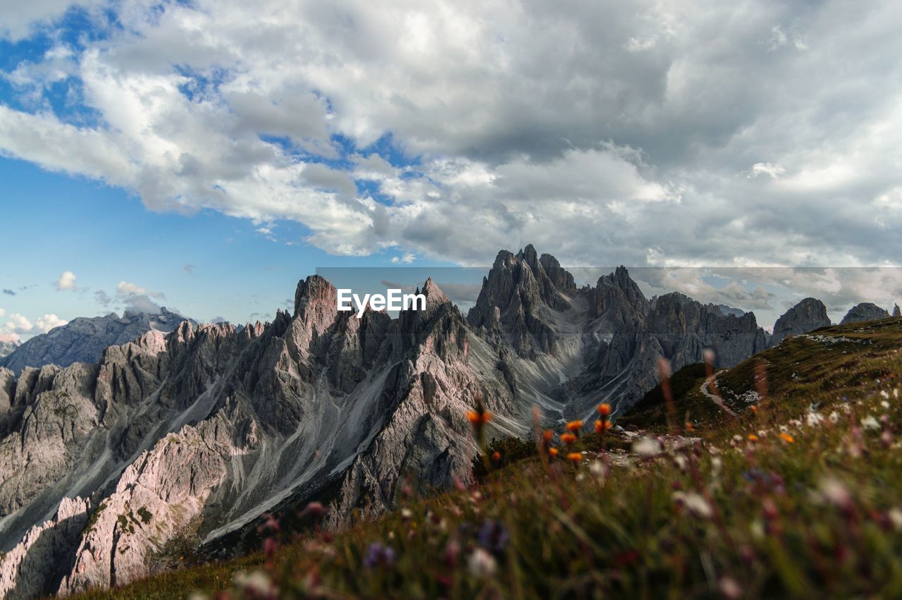 Scenic view of mountains against cloudy sky