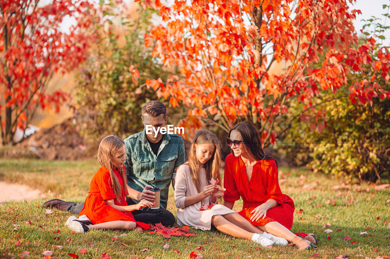 PEOPLE SITTING IN AUTUMN