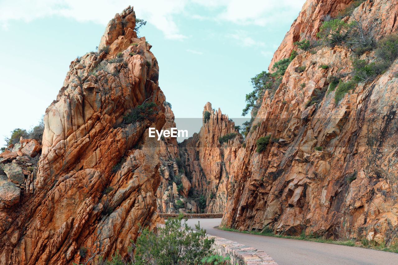 ROCK FORMATIONS ON MOUNTAIN AGAINST SKY