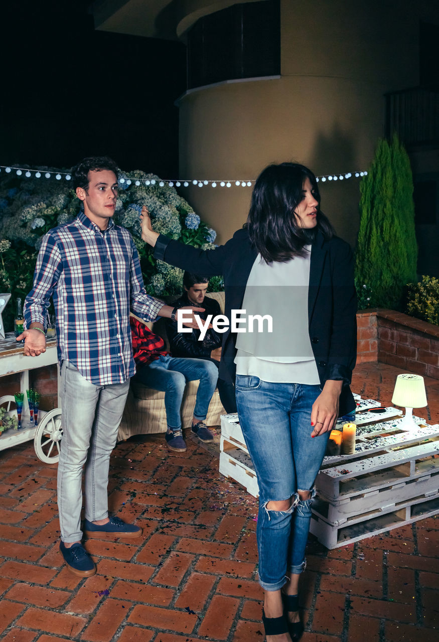 Young friends during party in backyard at night