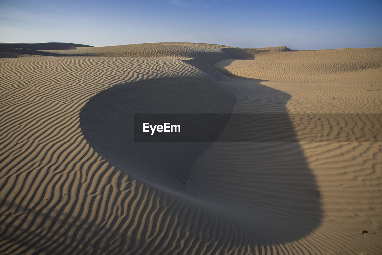 Shadow of sand dune in desert