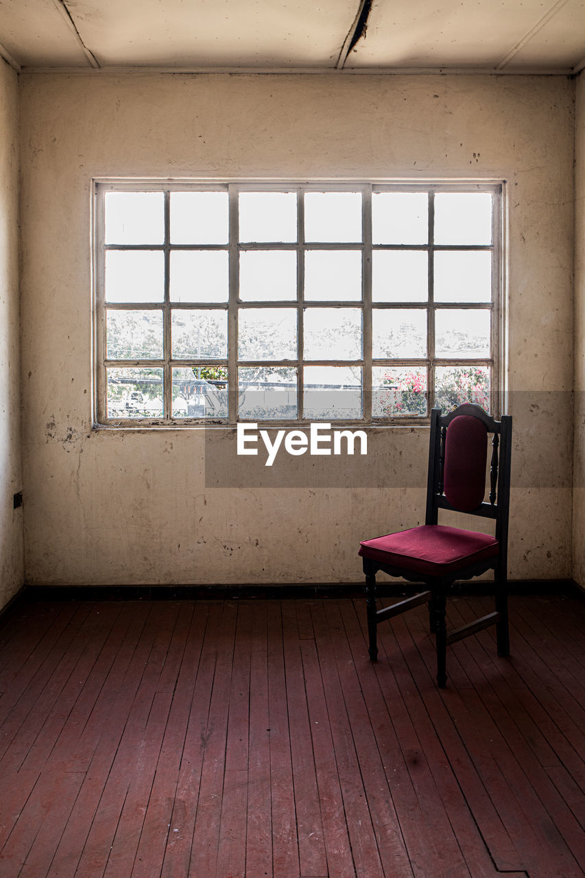EMPTY CHAIRS AND TABLES IN WINDOW