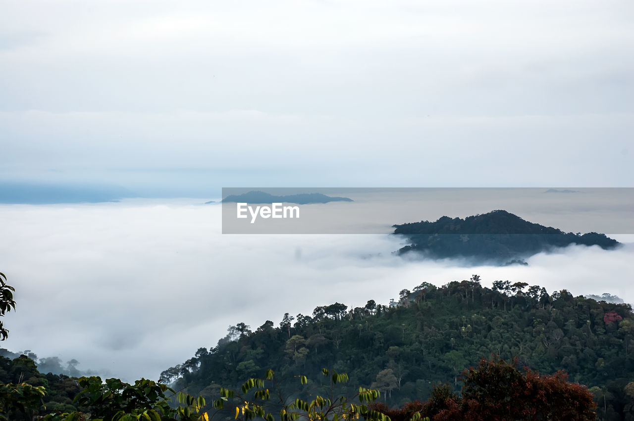 Scenic view of sea and mountains against sky