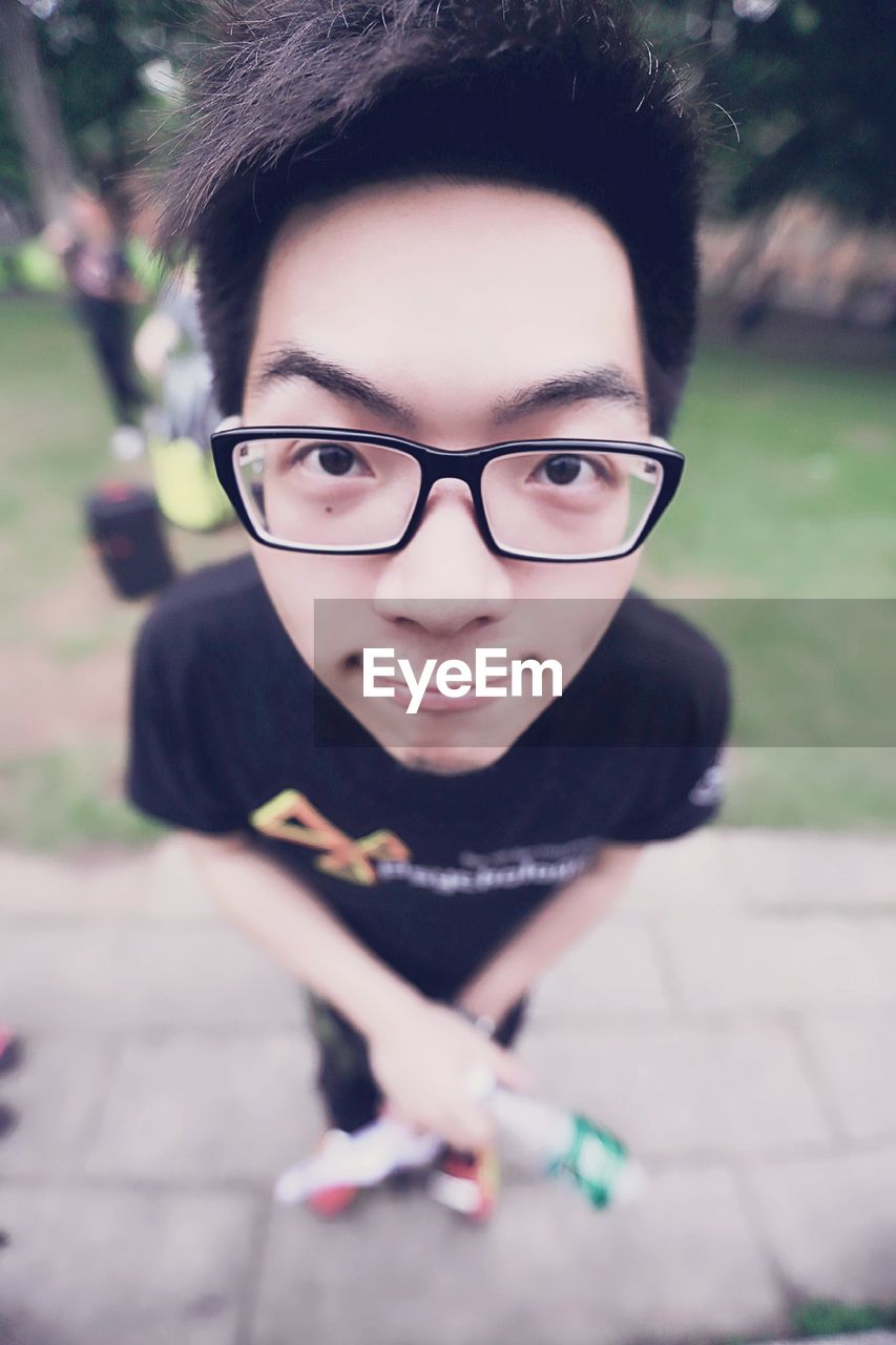 Close-up of portrait of young man wearing eyeglasses