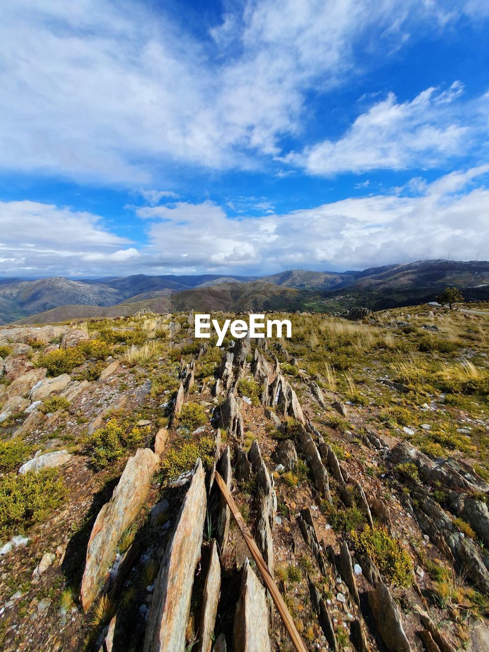 Panoramic view of land and mountains against sky