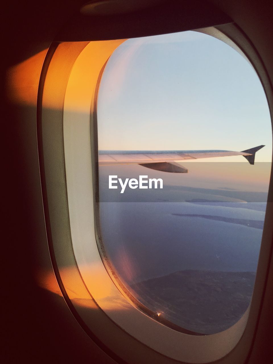 SCENIC VIEW OF SEA SEEN FROM AIRPLANE WINDOW