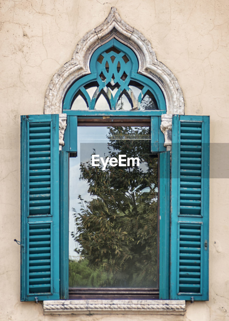 Typical venetian style window with nature reflected