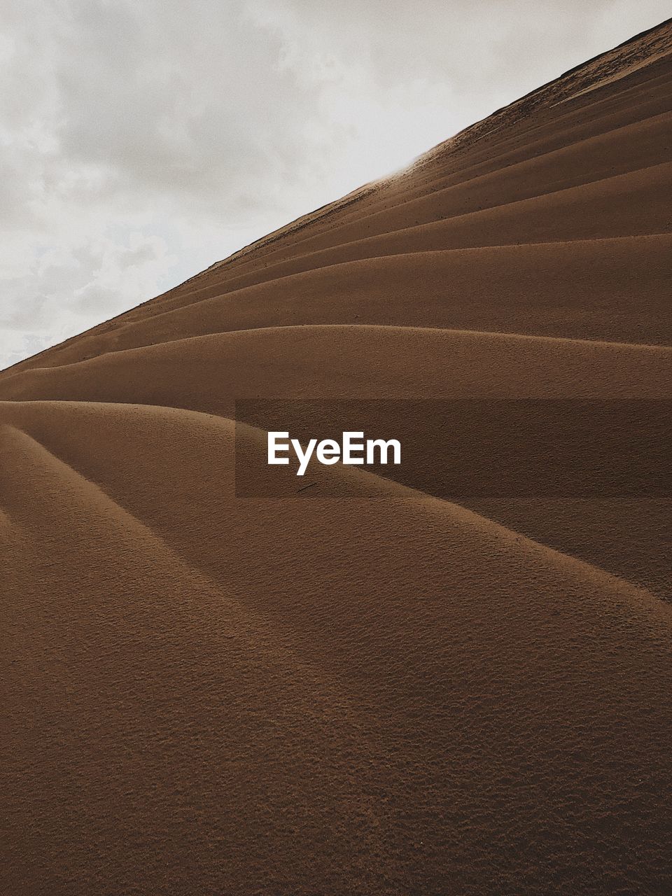 View of sand dunes against sky