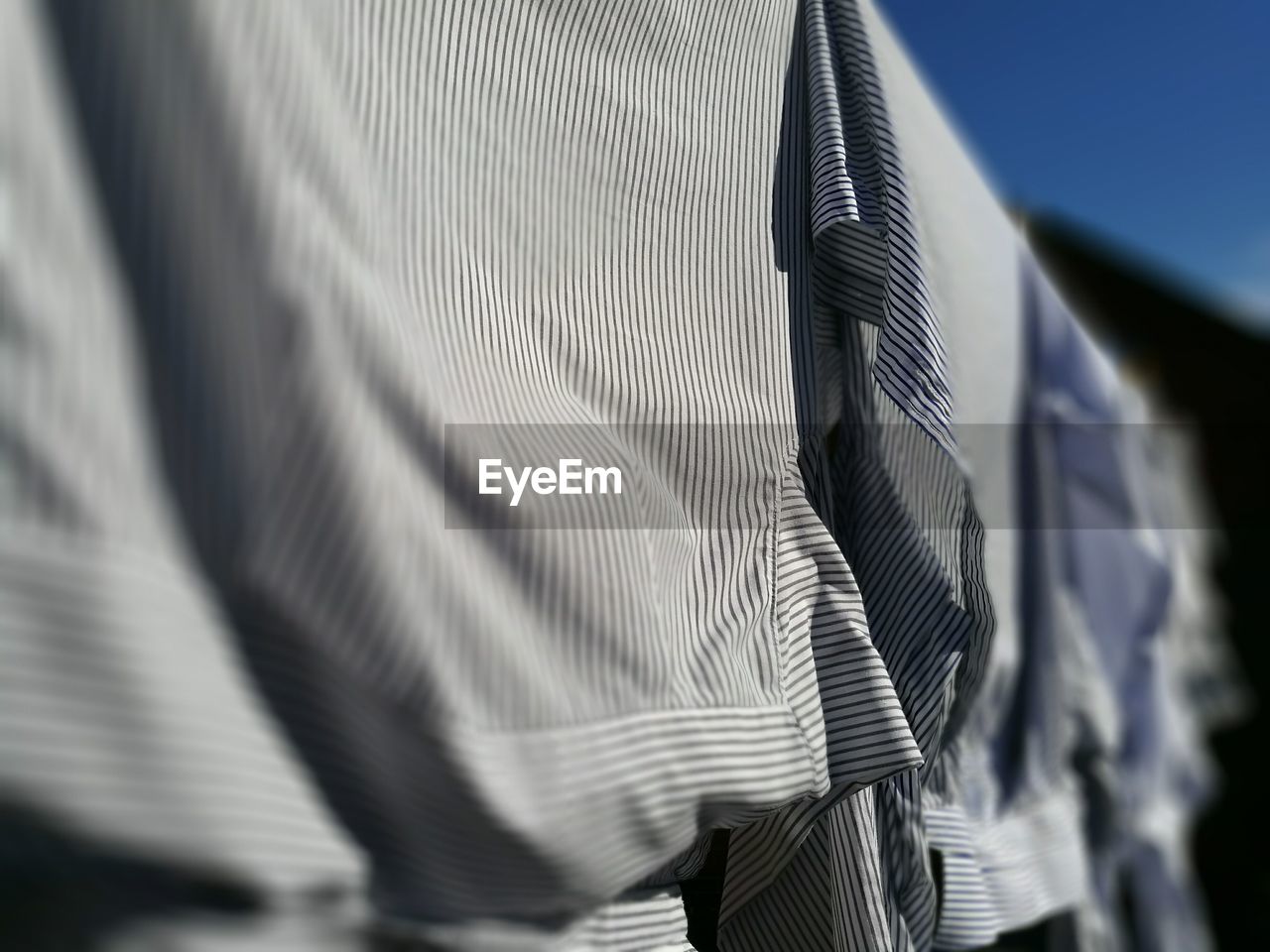 Close-up of shirts hanging outdoors