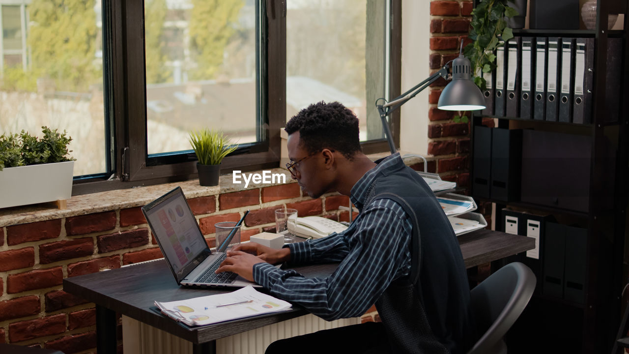 Businessman working on laptop in office