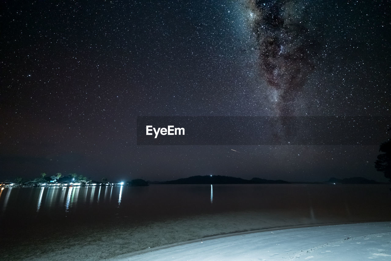 Scenic view of star field over lake