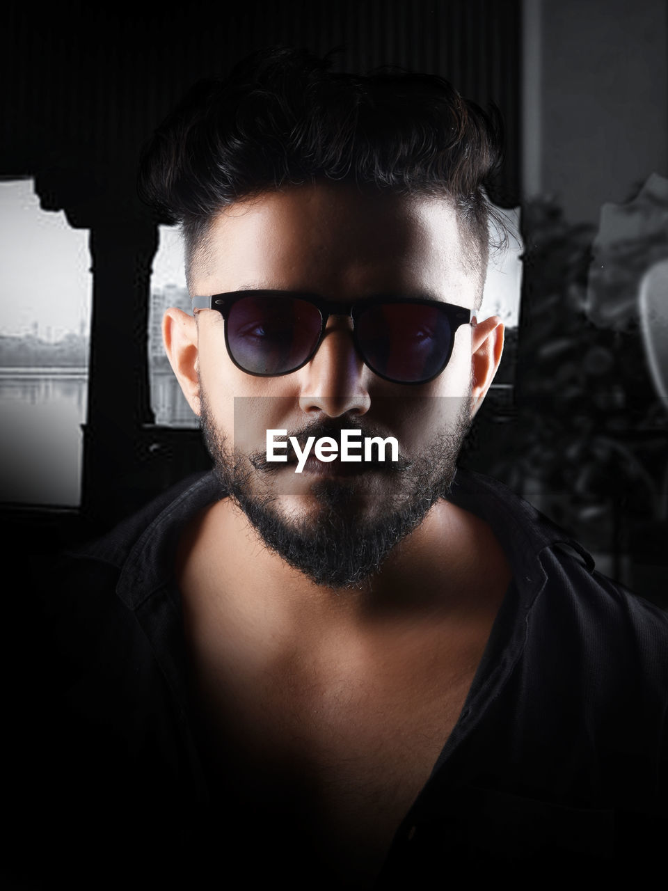 eyewear, fashion, black, vision care, portrait, sunglasses, one person, human hair, glasses, adult, facial hair, hairstyle, men, beard, headshot, young adult, dark, indoors, goggles, human face, darkness, cool attitude, looking at camera, moustache, serious, front view, cool, person, studio shot