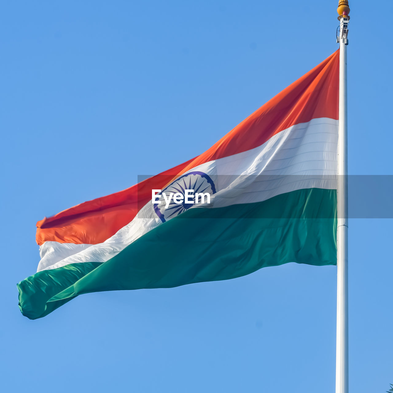 India flag flying high at connaught place with pride in blue sky, india flag fluttering, indian flag