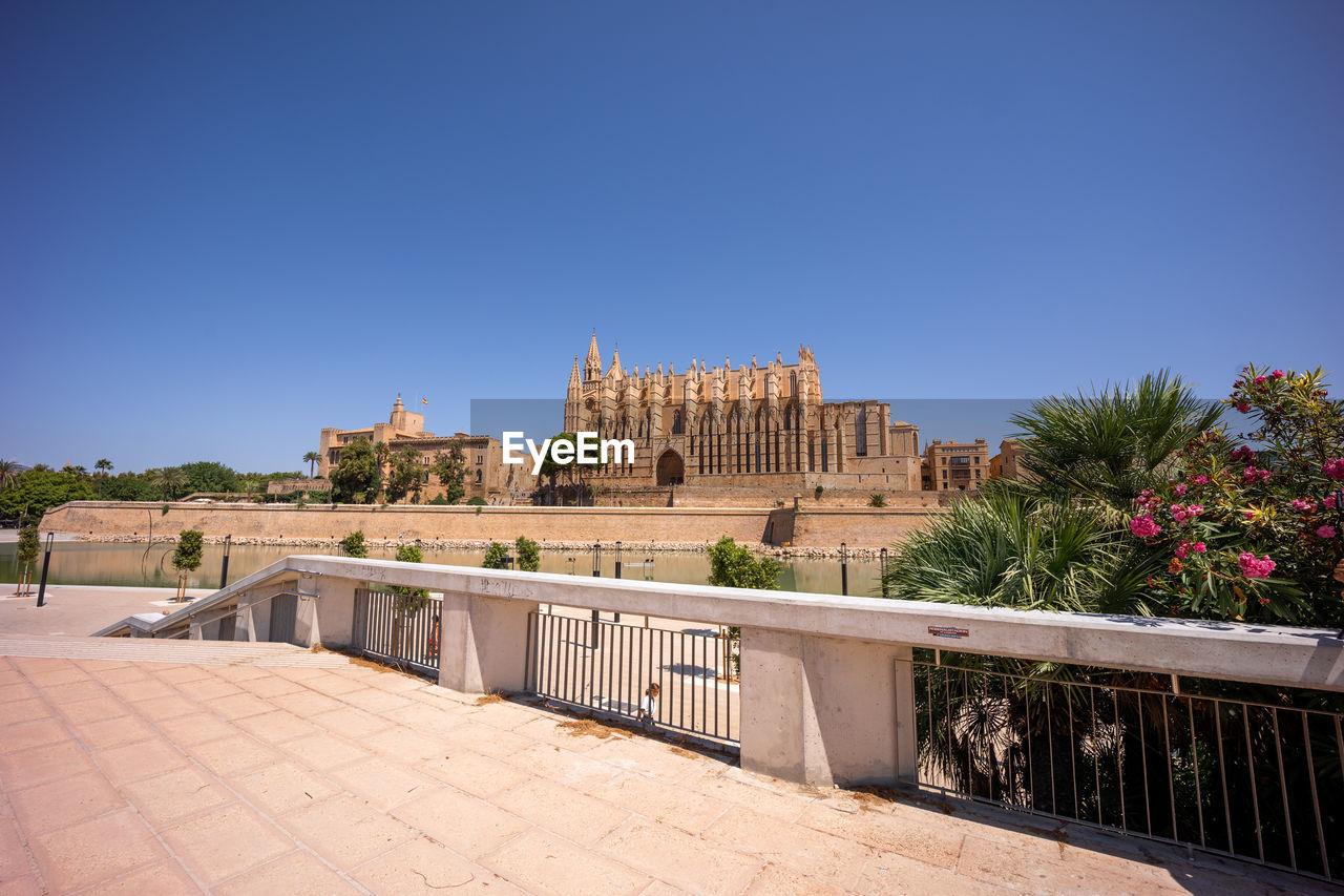 architecture, built structure, sky, building exterior, travel destinations, clear sky, blue, nature, history, vacation, city, the past, building, travel, plant, estate, sunny, tourism, tree, religion, no people, landmark, outdoors, copy space, mansion, palace, place of worship, cityscape