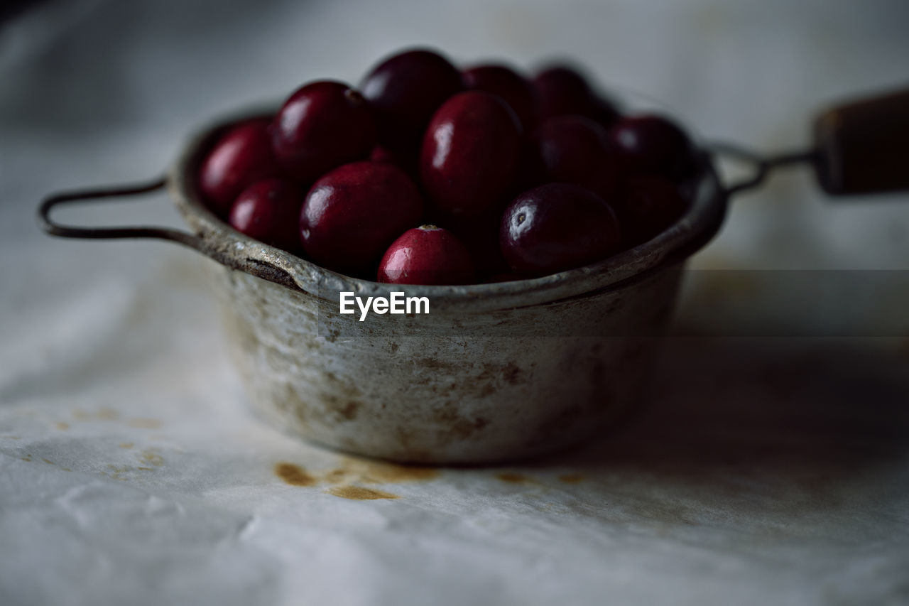 food and drink, food, healthy eating, fruit, freshness, produce, wellbeing, indoors, bowl, plant, no people, close-up, kitchen utensil, wood, still life, selective focus, red, cherry, table, sweet food, household equipment, dessert