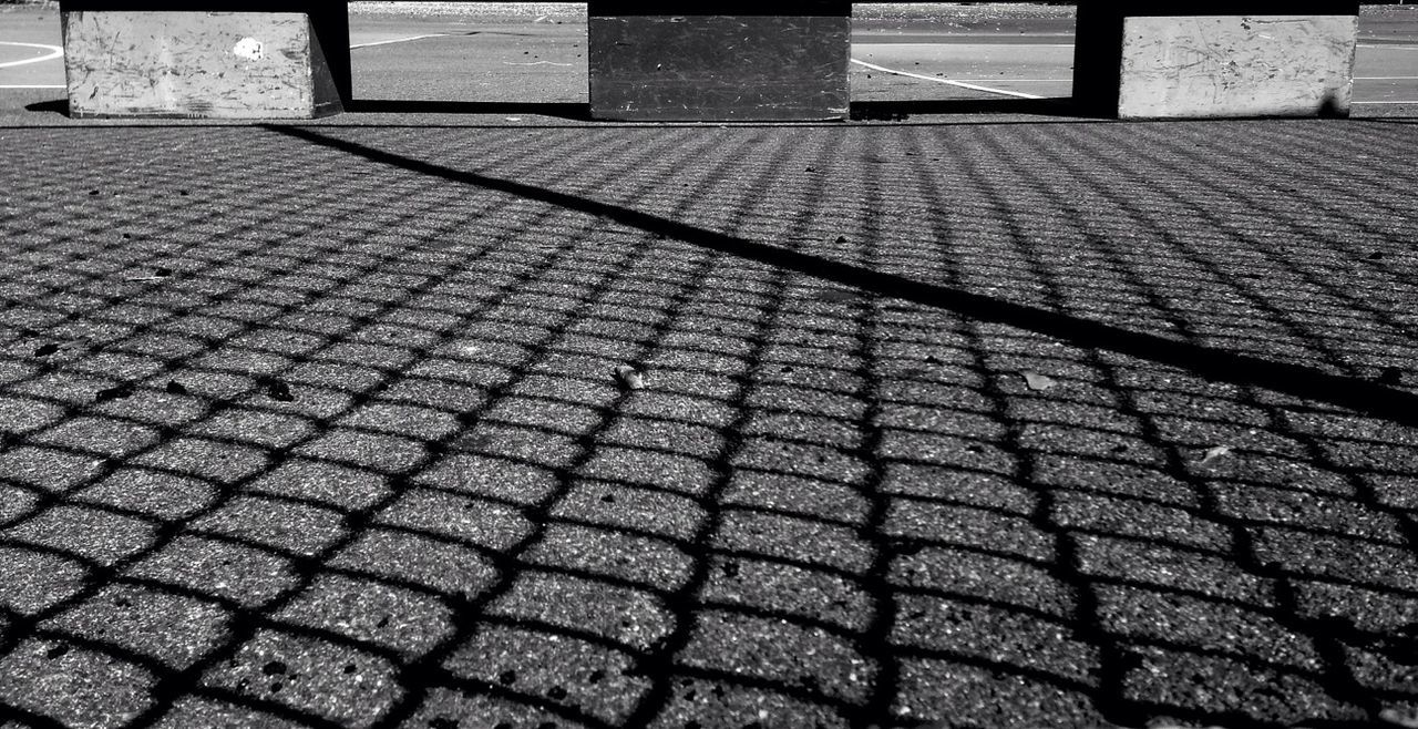 Shadow of fence on ground