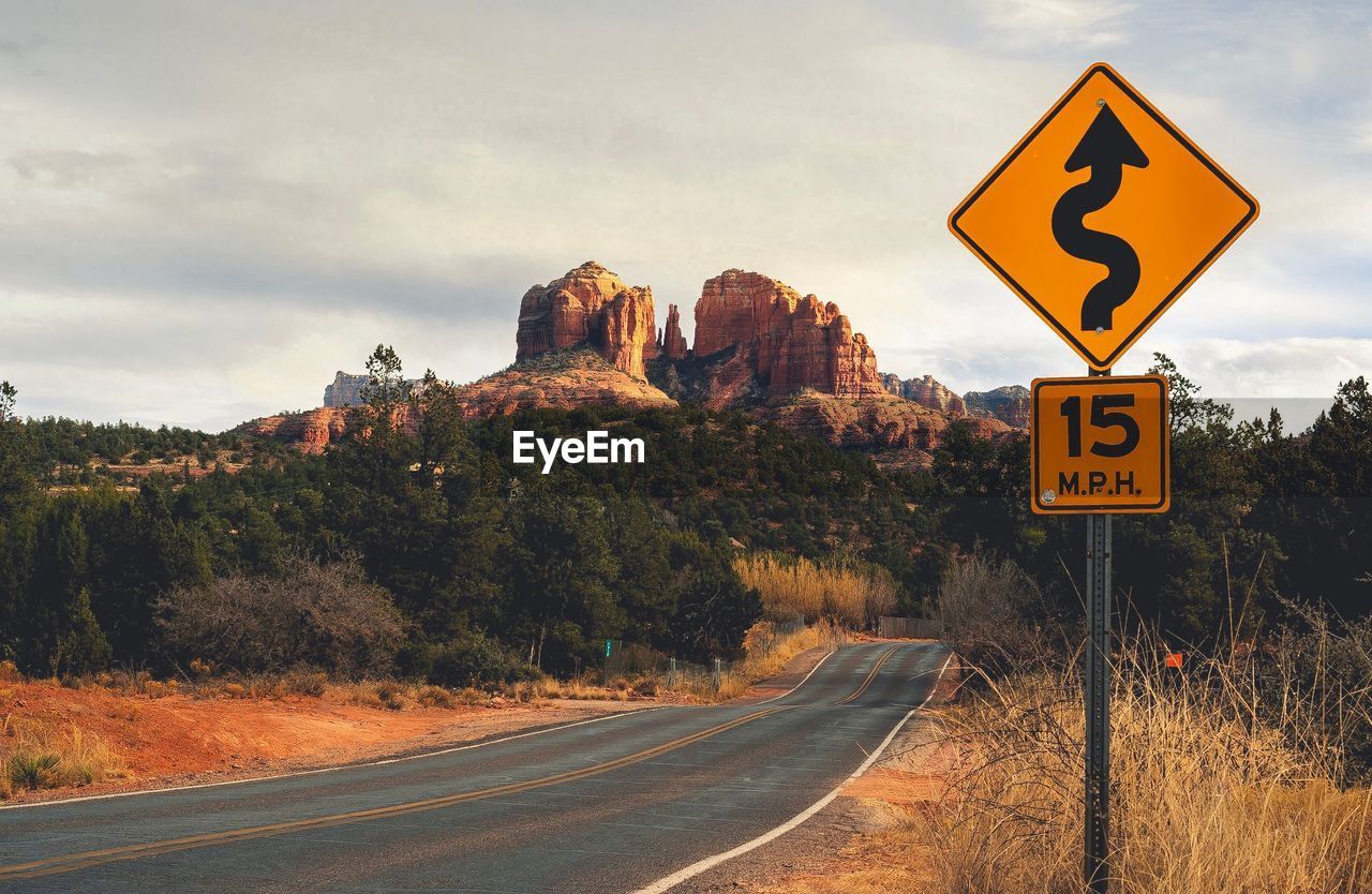 Road sign against sky