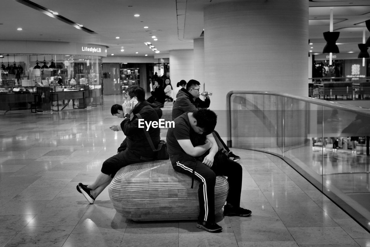 PEOPLE SITTING ON SHOPPING MALL