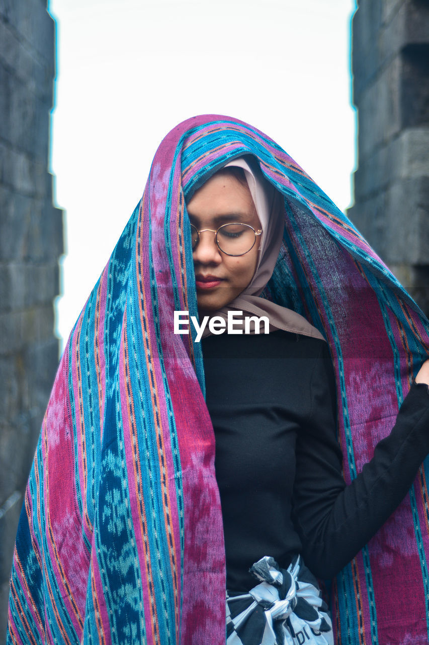 Beautiful young woman in traditional indonesian woven cloth
