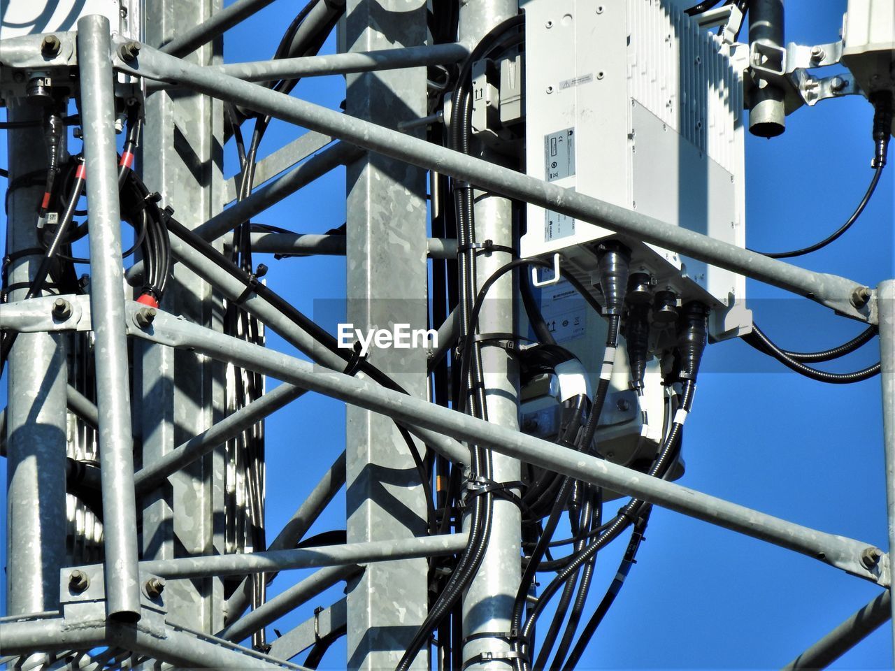 LOW ANGLE VIEW OF CABLES AGAINST BLUE SKY