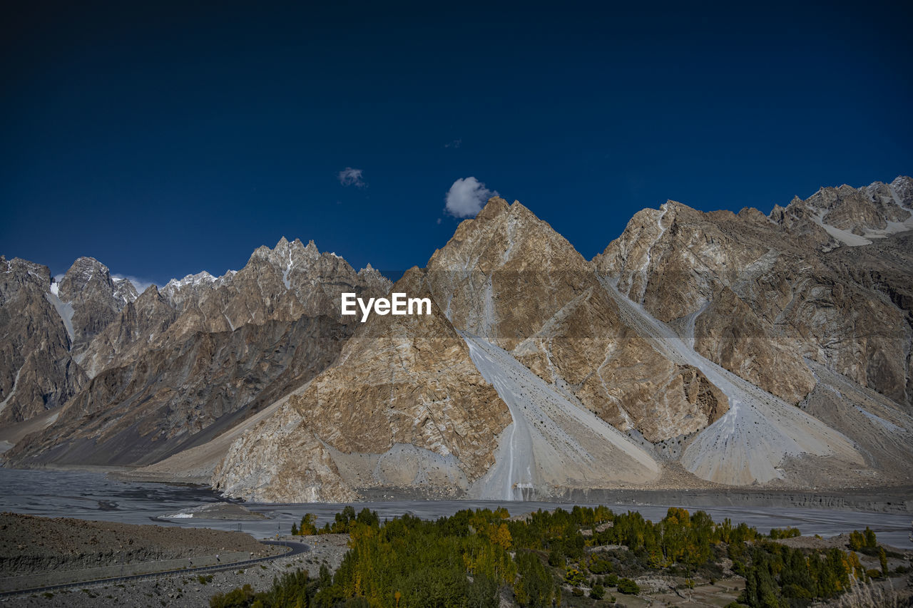 Scenic view of rocky mountains against blue sky at night