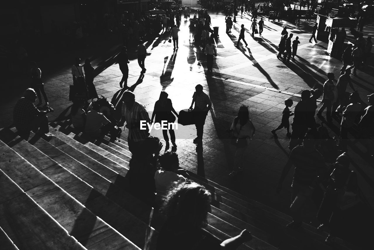 HIGH ANGLE VIEW OF PEOPLE WALKING ON RAILWAY STATION