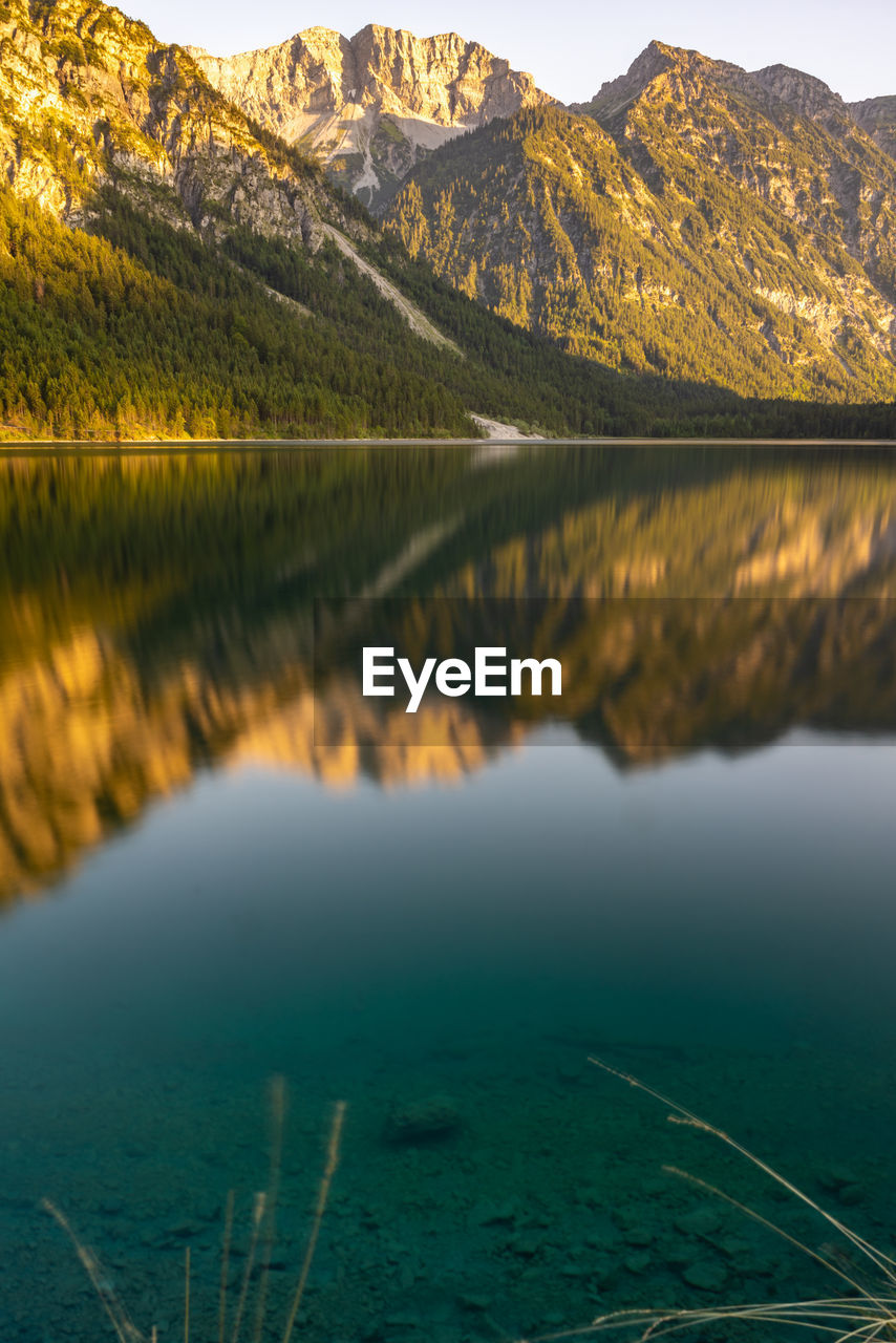 Scenic view of lake and mountains against sky