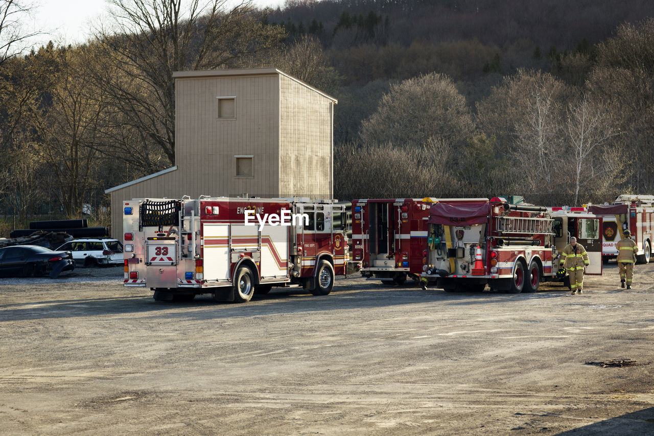 Firefighters walking by fire engine