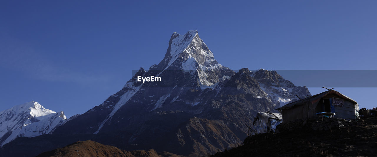 VIEW OF SNOWCAPPED MOUNTAIN AGAINST SKY