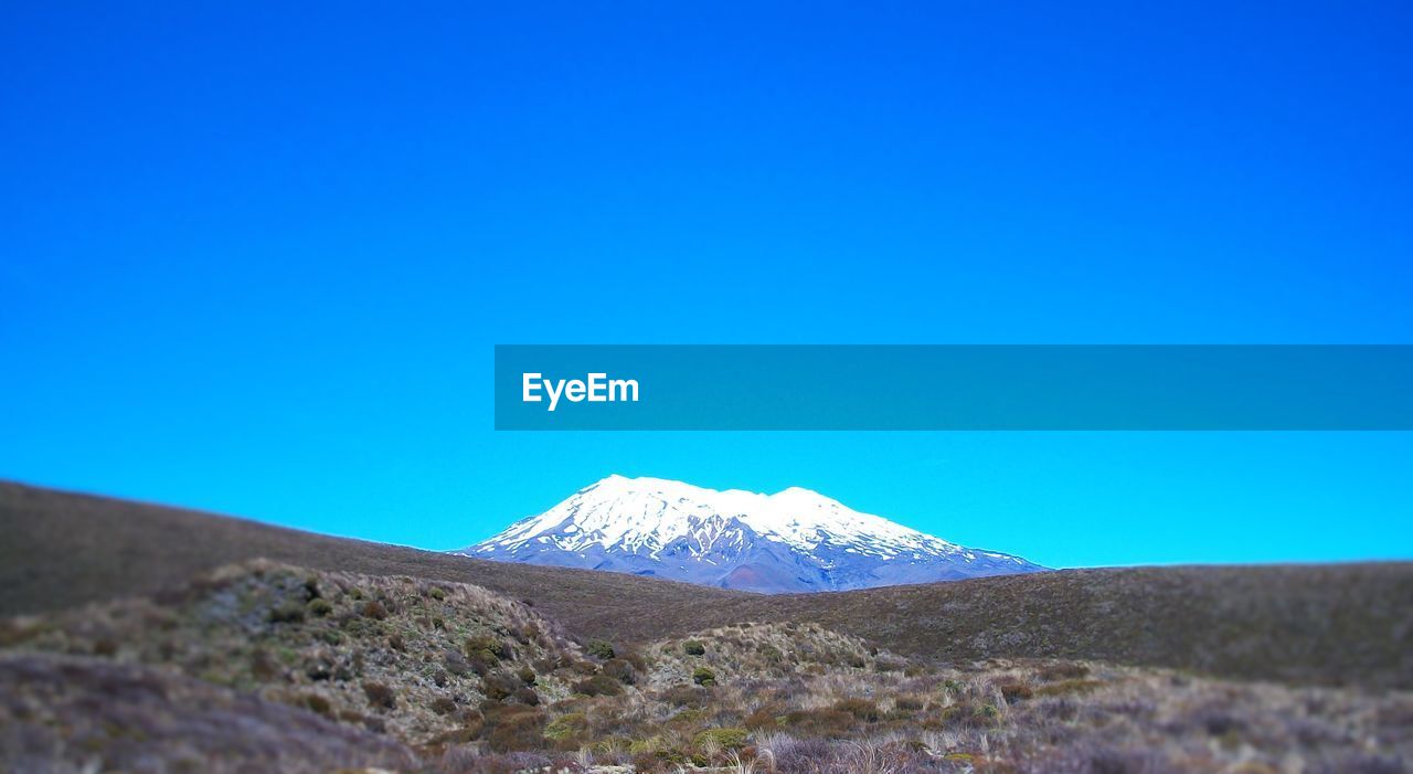 SNOWCAPPED MOUNTAIN AGAINST CLEAR BLUE SKY