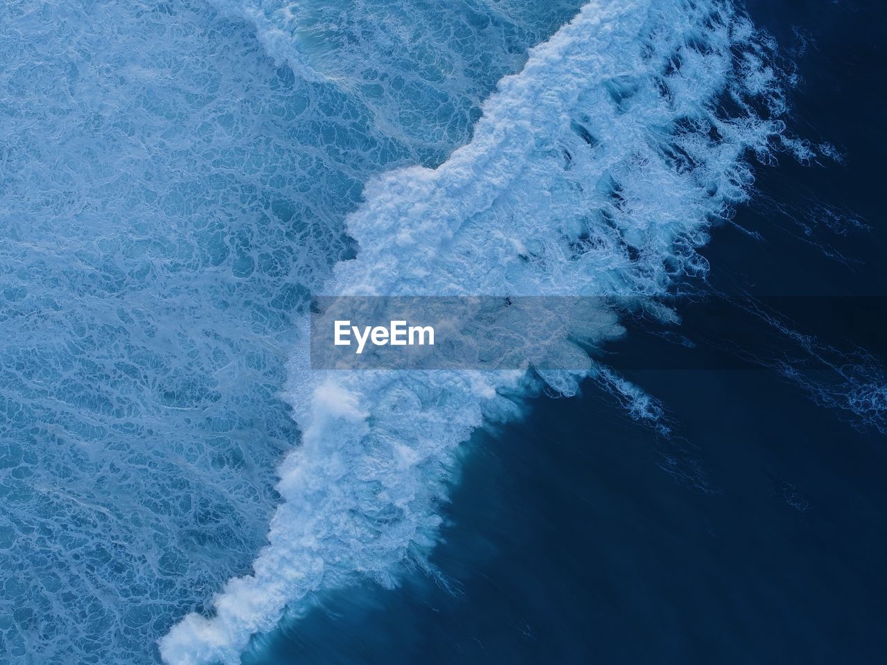 High angle view of waves splashing in sea