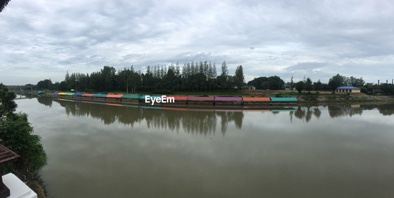 SCENIC VIEW OF CALM LAKE AGAINST SKY