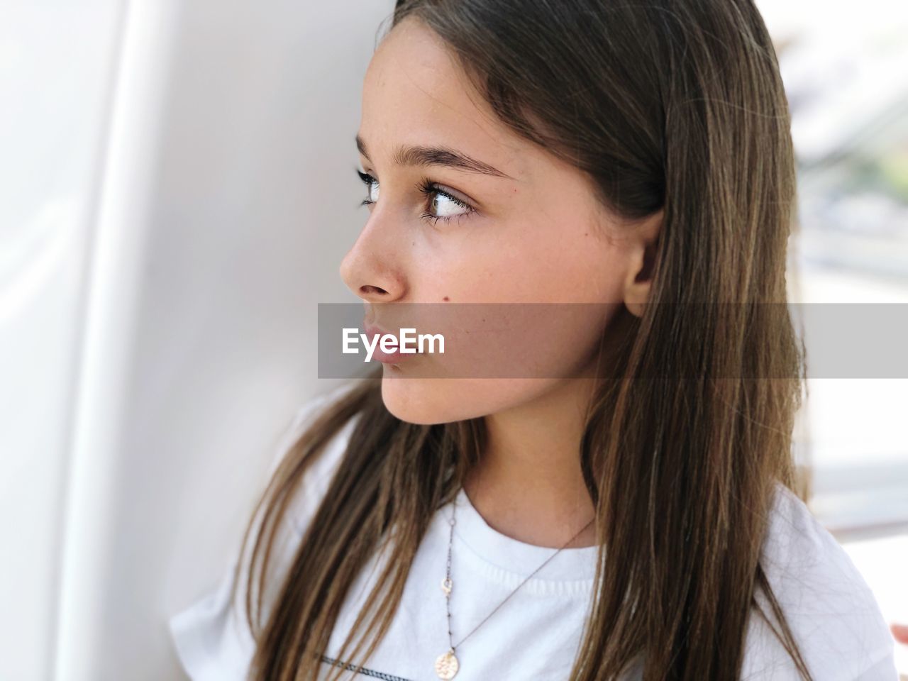 Close-up of girl looking away at home