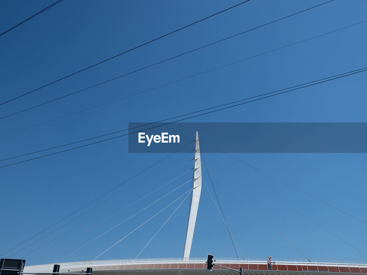 Low angle view of modern bridge against clear blue sky