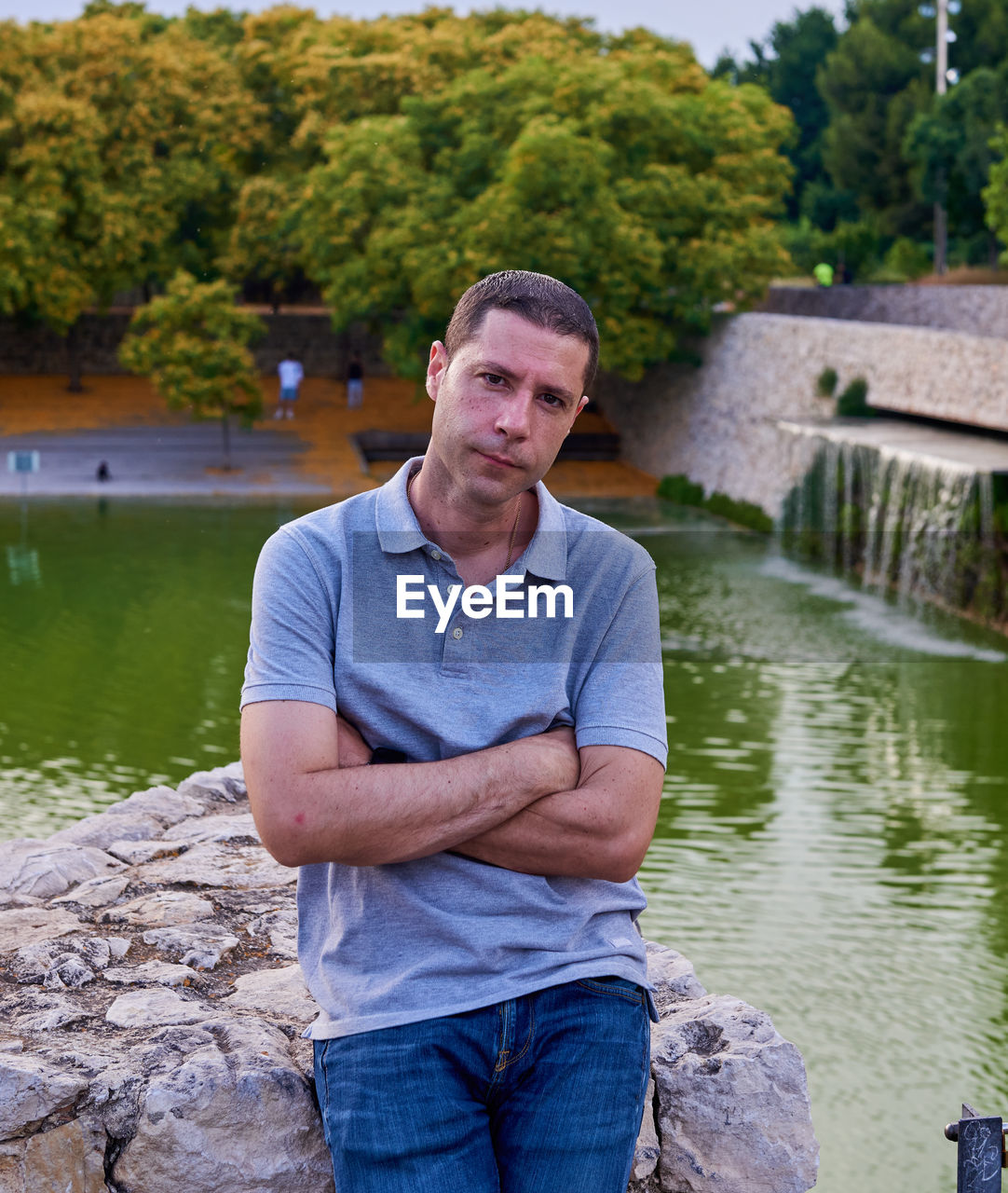 water, one person, adult, men, nature, river, portrait, casual clothing, tree, front view, day, plant, three quarter length, person, looking at camera, standing, jeans, architecture, outdoors, pond, lifestyles, leisure activity, mature adult, vacation, clothing, emotion, looking