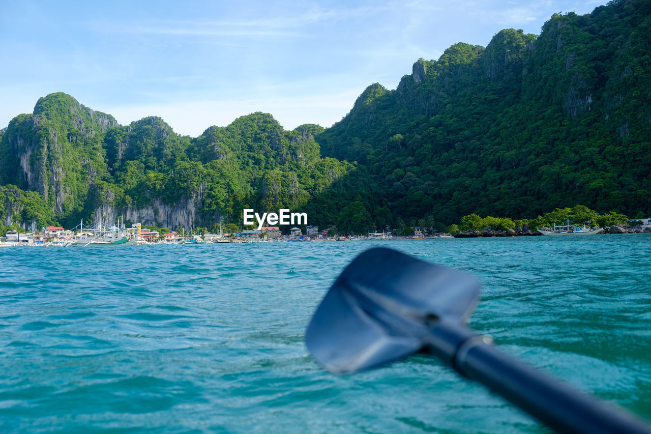 Scenic view of sea and mountains against sky