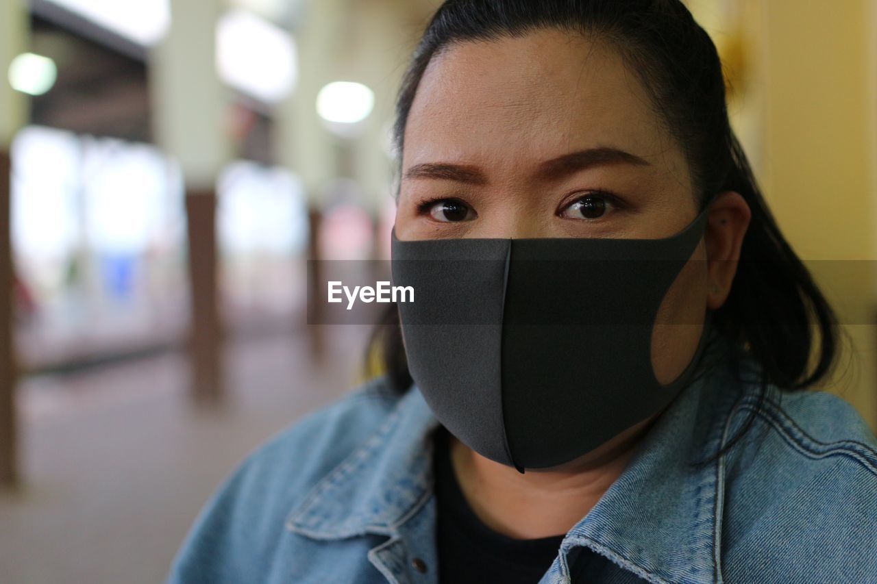 Close-up of woman wearing flu mask outdoors