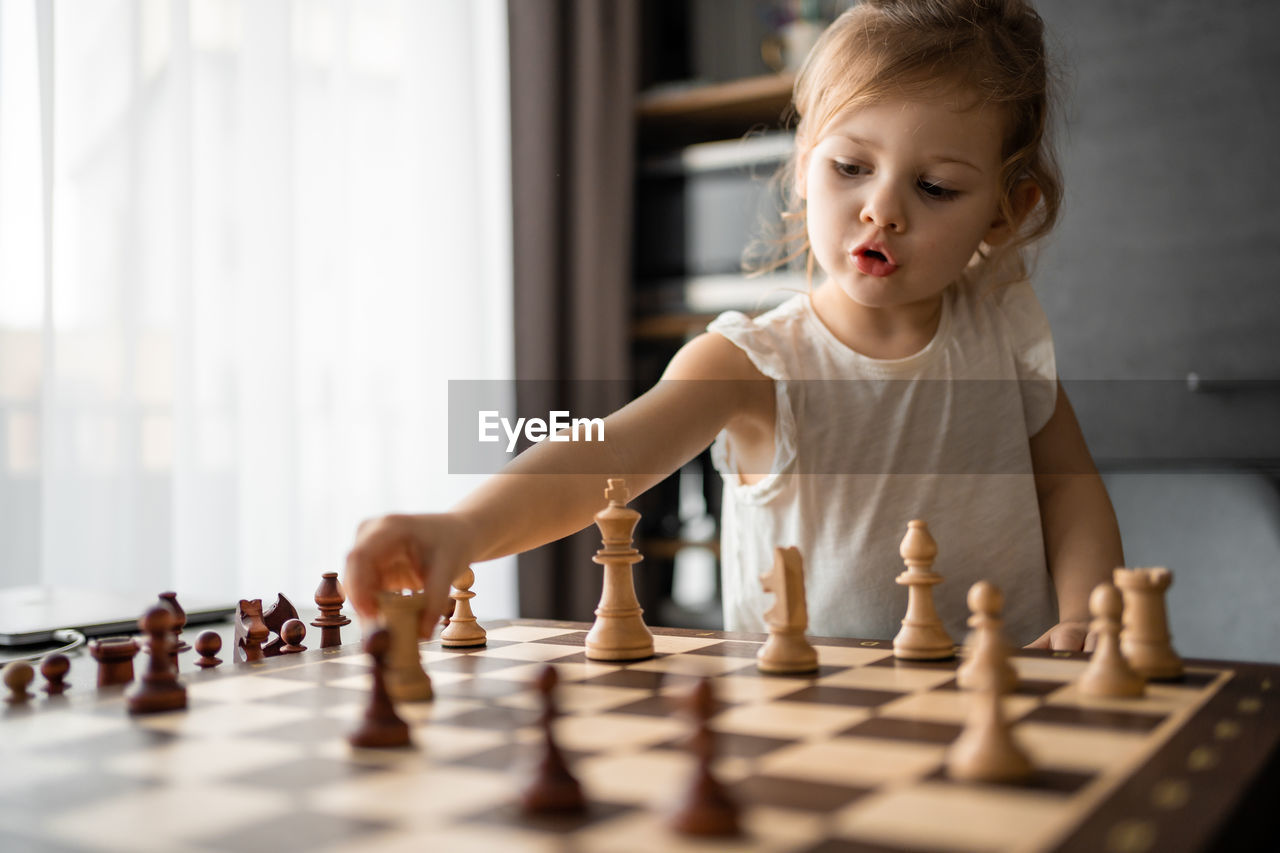 portrait of boy playing with toy blocks at home