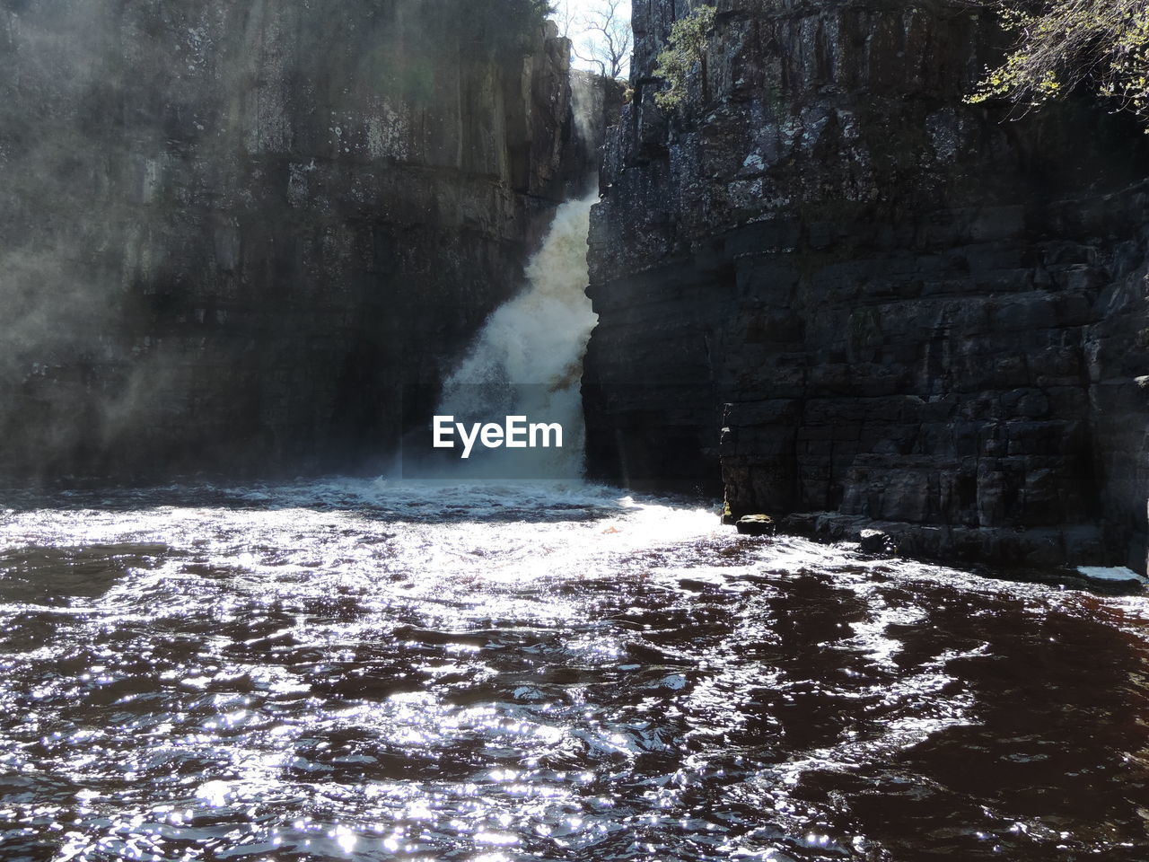 SCENIC VIEW OF WATERFALL IN FOREST