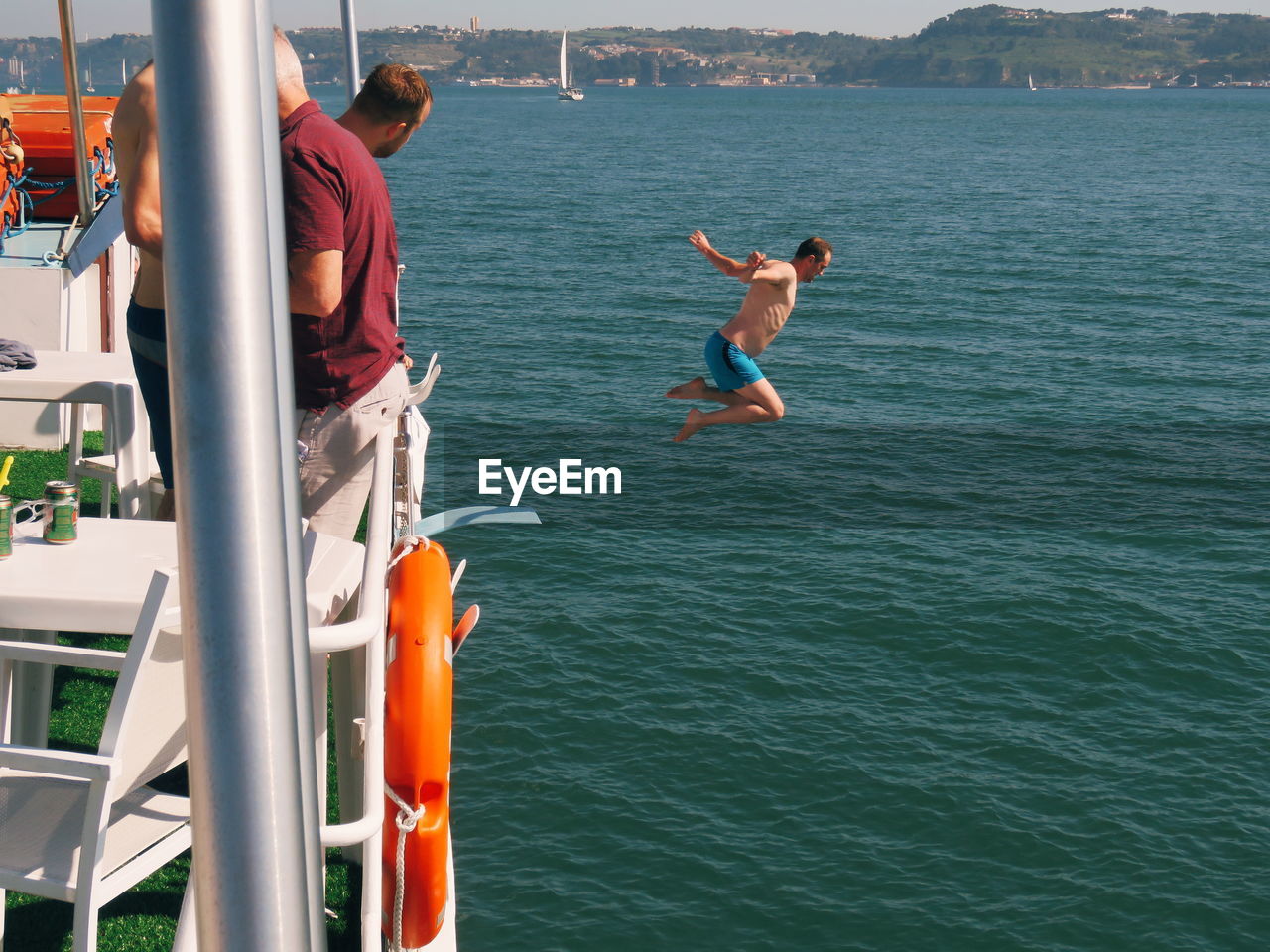 PEOPLE JUMPING ON SEA