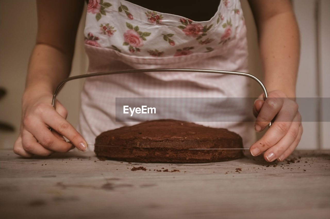 Woman cutting cake in half