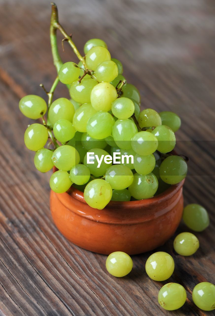 High angle view of grapes in container on table