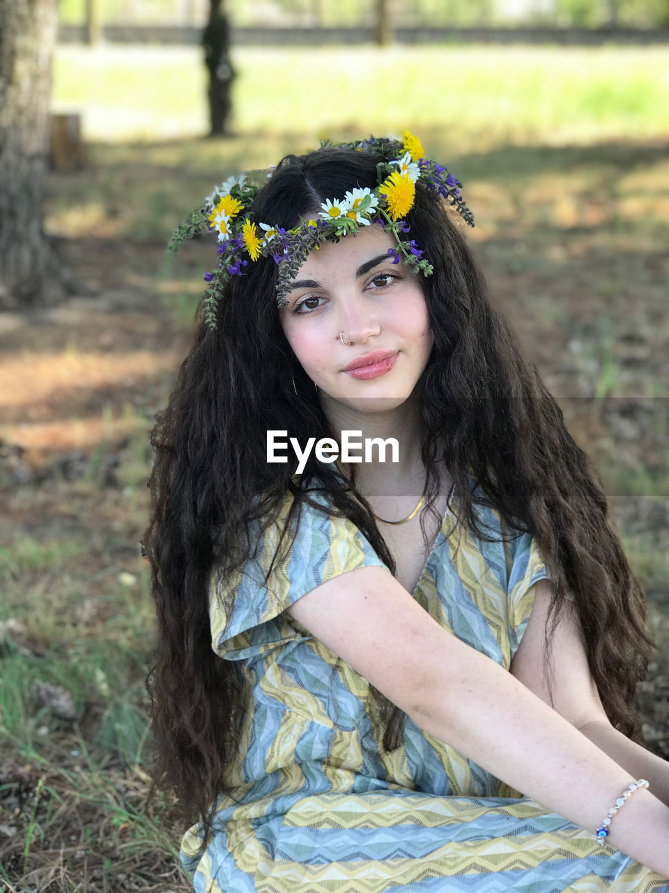 Portrait of smiling young woman standing in forest